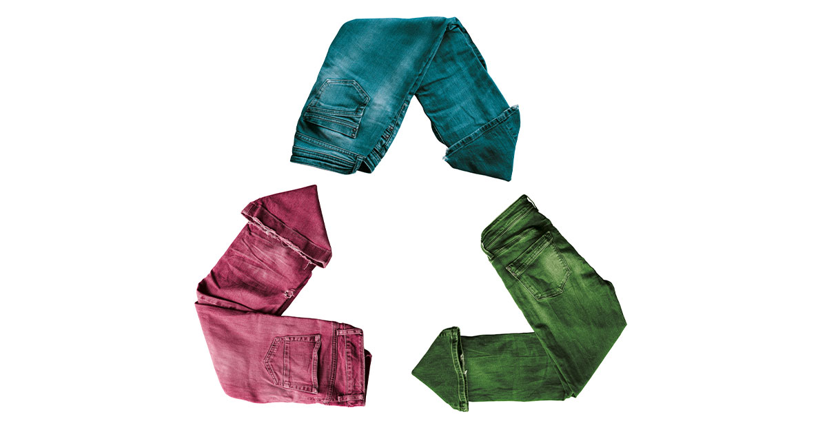 Sustainable fashion blue jeans in a recycle symbol