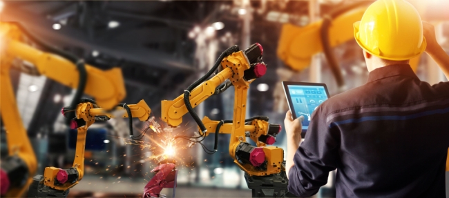 Engineer check and control welding robotics automatic arms machine in intelligent factory automotive industrial with monitoring system software.