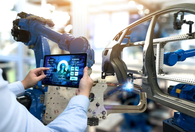 Engineer hand using tablet with machine real time monitoring system software 