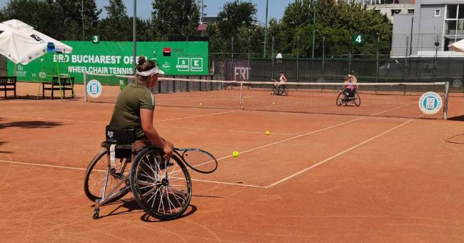 Women play wheelchair tennis in the ITF tournament