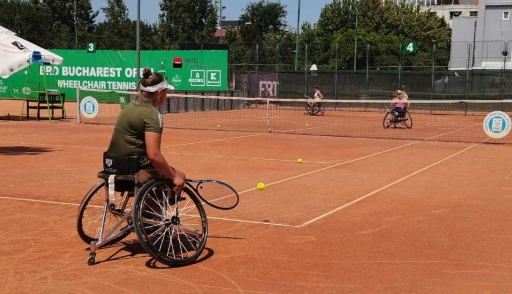 Women play wheelchair tennis in the ITF tournament