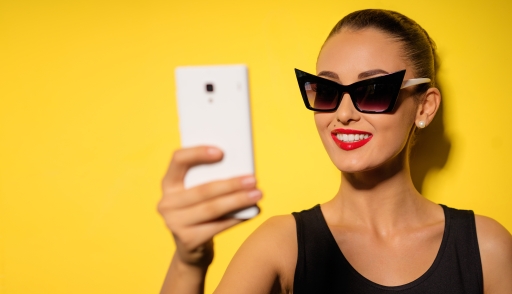 Fashionable influencer taking a selfie with her new stylish sunglasses on