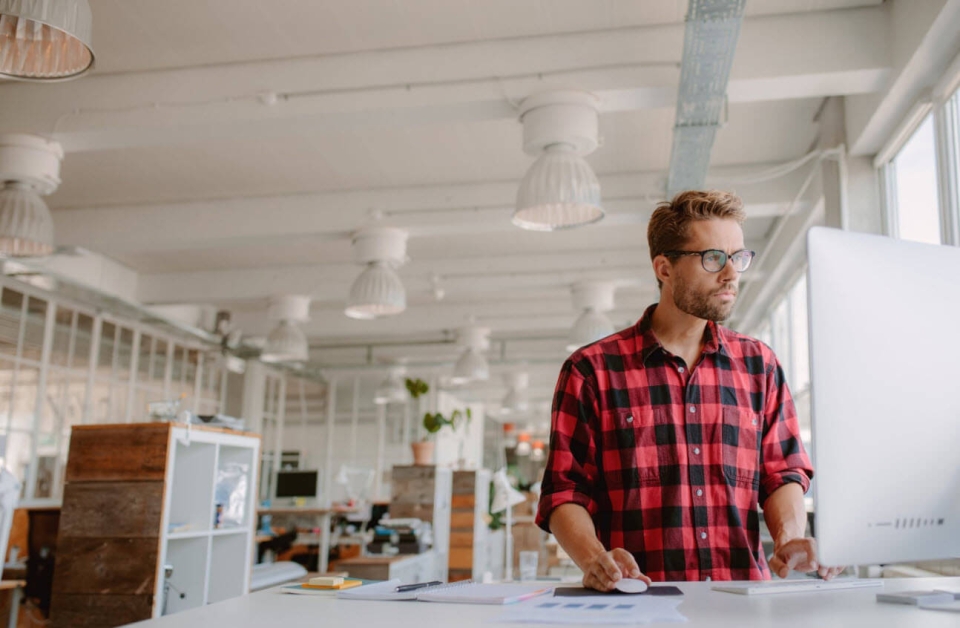 Man at his desk in a startup wondering if his company is too small to outsource