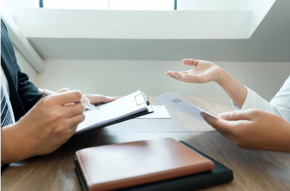 Woman asking a colleague if it's time to outsource