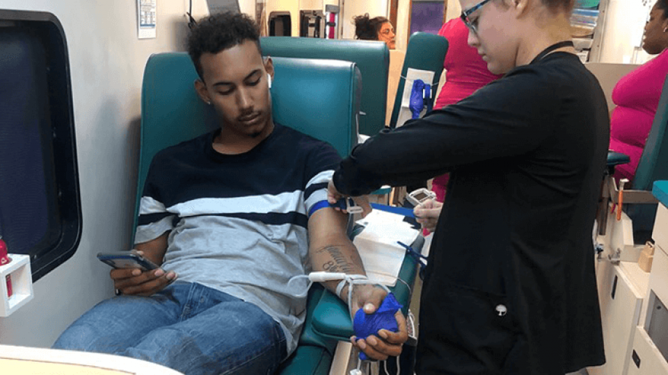 A CGS staff member donating blood