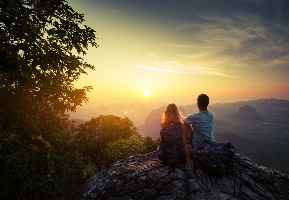 Couple finishing their hike at the top of a mountain