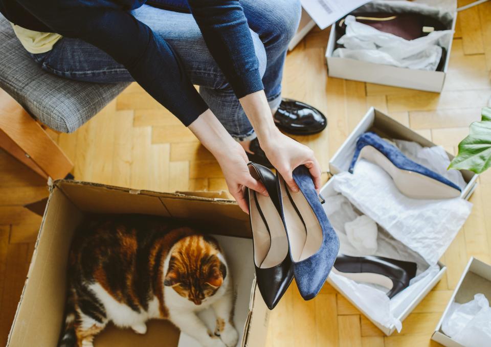 Woman opening boxes of shoes